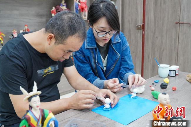 <a target='_blank'  data-cke-saved- >中新社</a>記者(右)現(xiàn)場體驗(yàn)面塑制作過程?！￡悹帍?qiáng) 攝