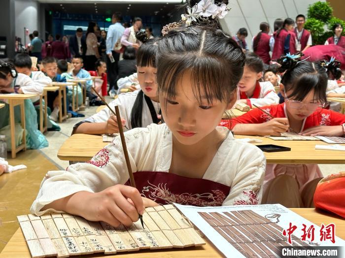 圖為小朋友在甘肅簡牘博物館練習(xí)書法?！≈行律缬浾?戴文昌 攝